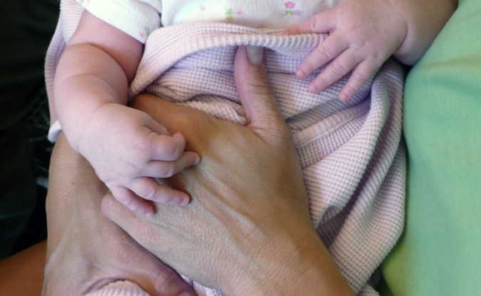 baby being held ~ safety file image